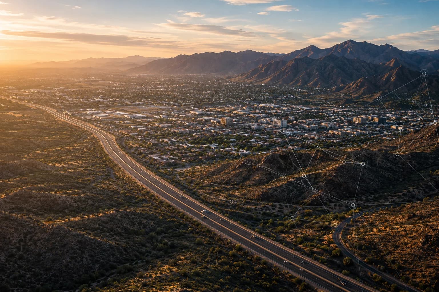 Aerial view of an Arizona city and desert landscape with mountains and transportation infrastructure